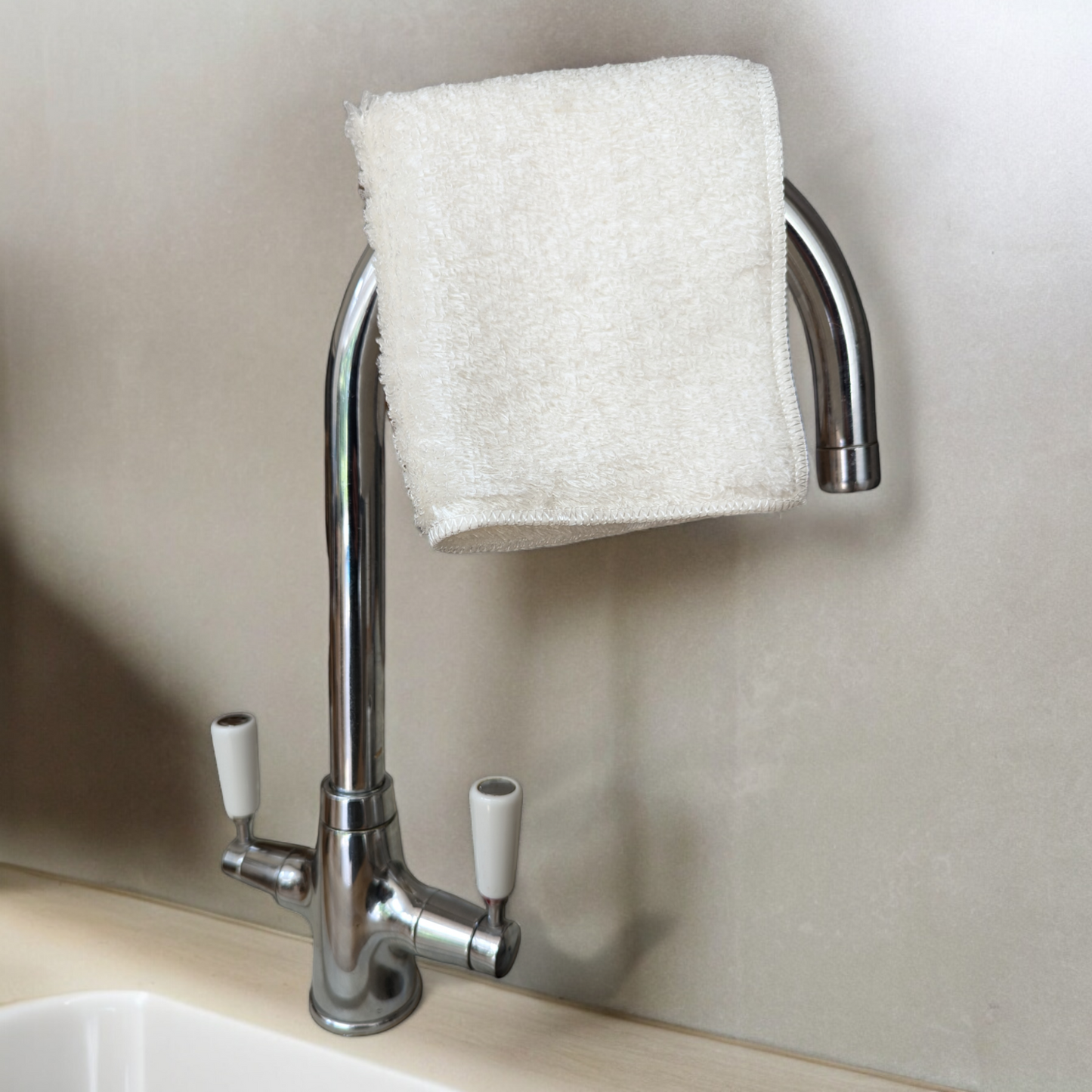 bamboo dish cloth on tap over kitchen sink