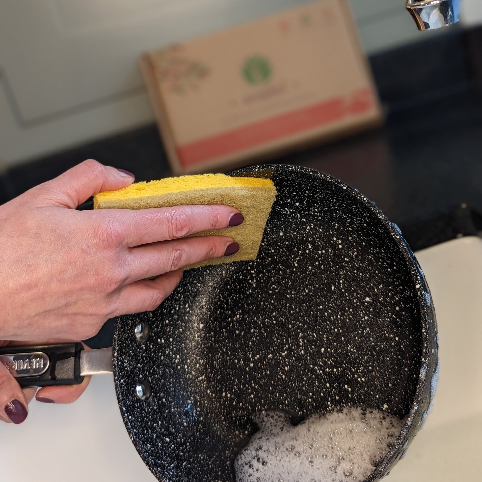 woman cleaning pan with ecojiko cellulose sponge scourers