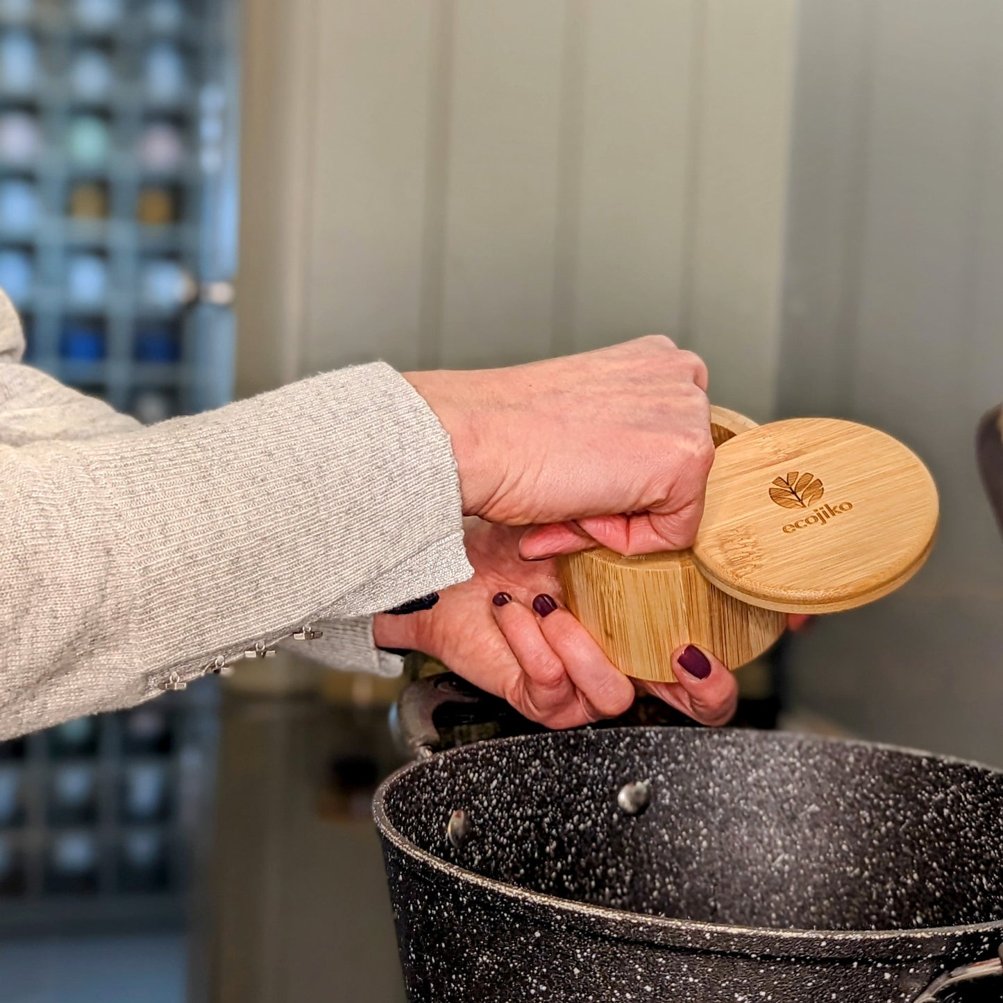 woman using salt and spice pot in kitchen