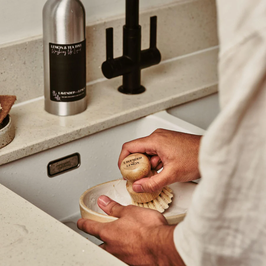 woman cleaning dishes with bamboo plastic free customised zero waste scrubbing brush