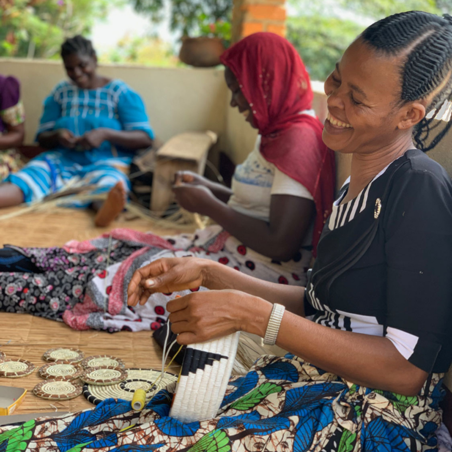 woman weaving Fair Trade grass coasters