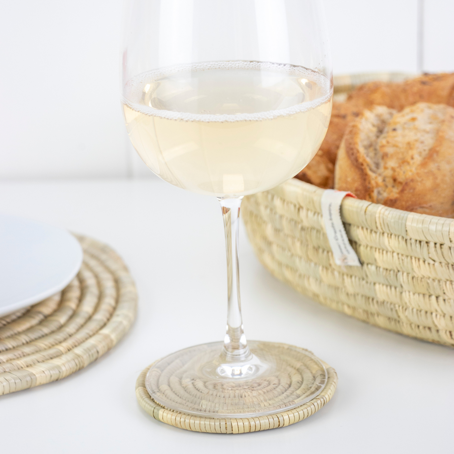 glass of wine on grass coaster