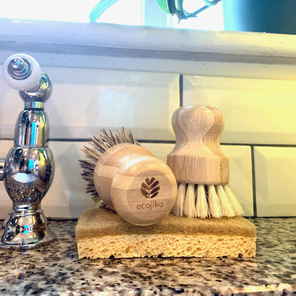 eco friendly bamboo scrubbing brushes on sink with cellulose sponge