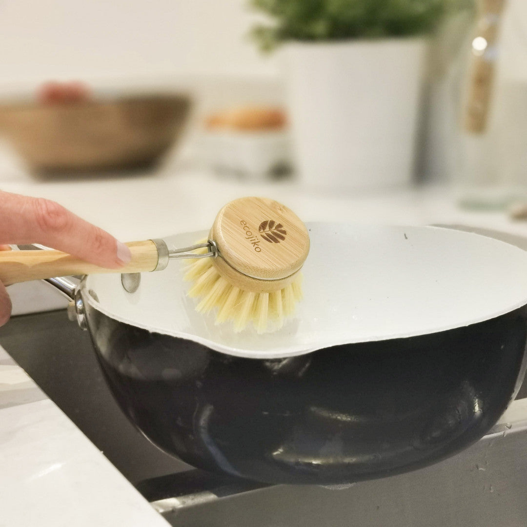 washing a pan with an ecojiko bamboo dish brush