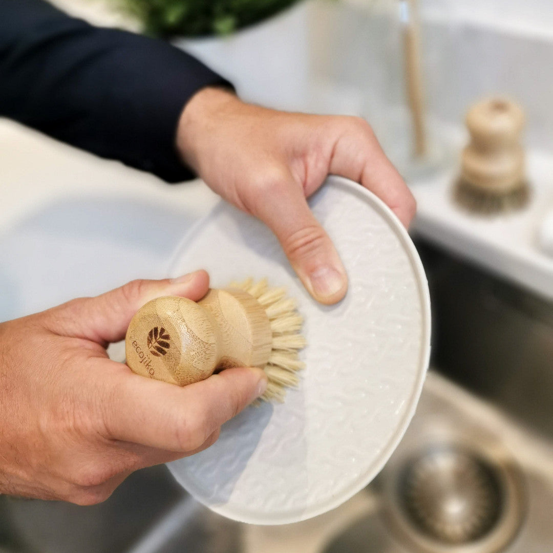 man washing up with bamboo and sisal scrubbing brush