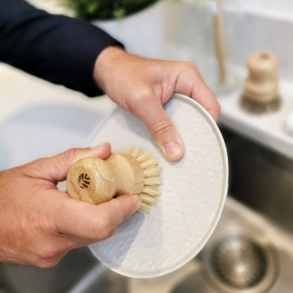man washing up with bamboo and sisal scrubbing brush